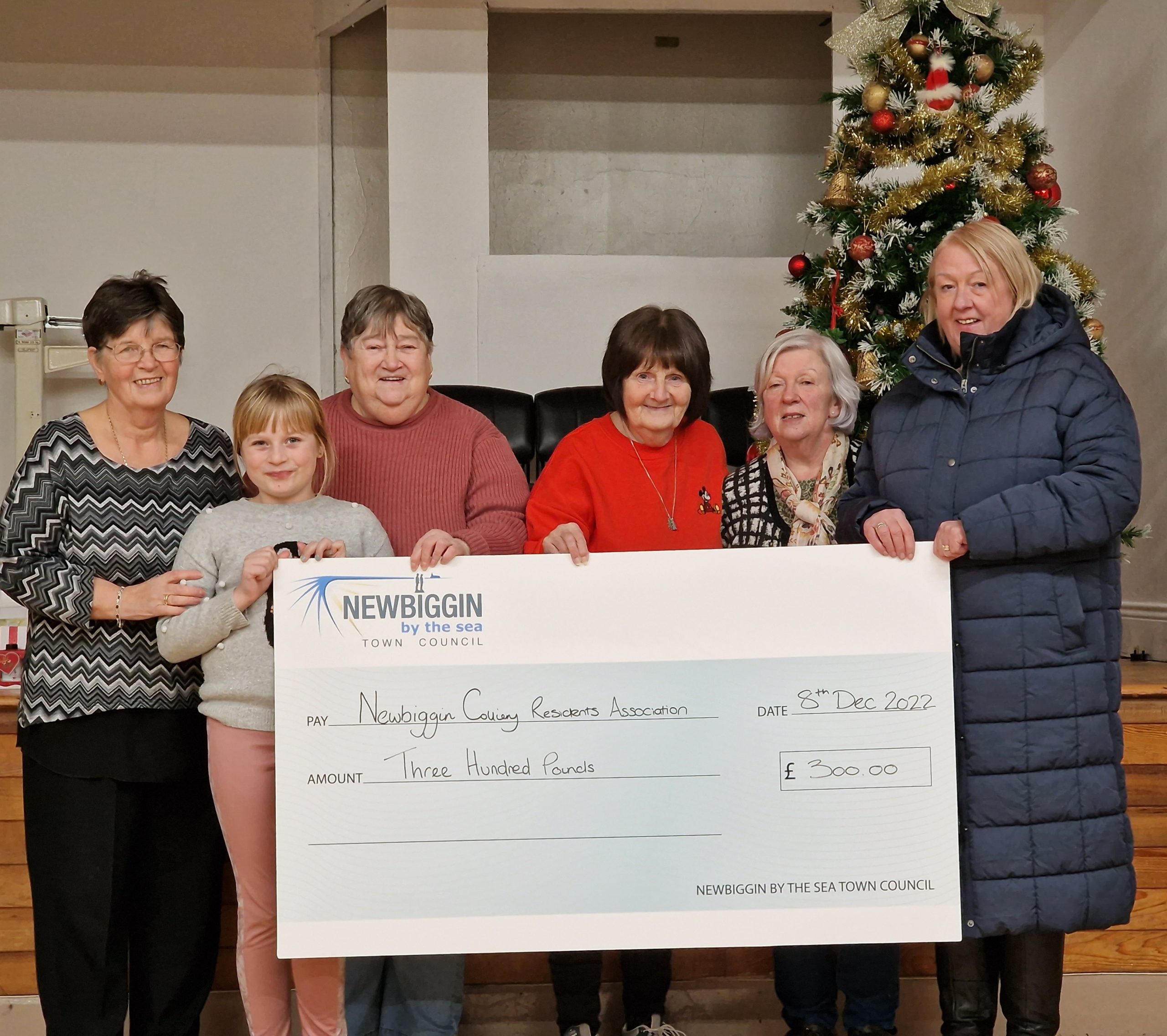 Councillor Alison Sutherland presenting a cheque to the members of Newbiggin Colliery Residents Association.